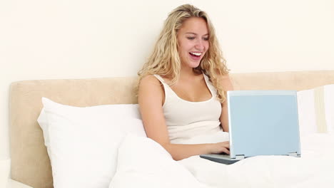 Laughing-woman-using-a-laptop