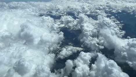 aerial view from a jet cockpit while overflying the alps mountains covered with some snow