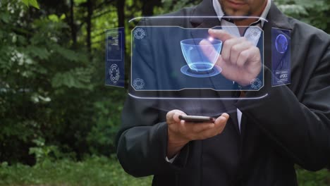 businessman uses hologram with cup of coffee