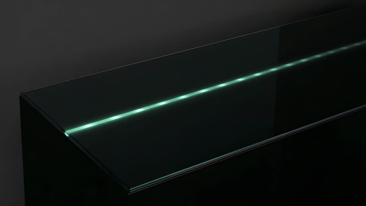 Starting left segment, bright green linear light extending along panel on dark wall, creating halo