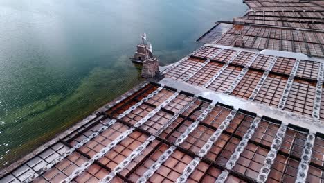 beautiful aerial drone footage of the salinas de janubio salt flats at sunset in lanzarote, canary islands, spain.