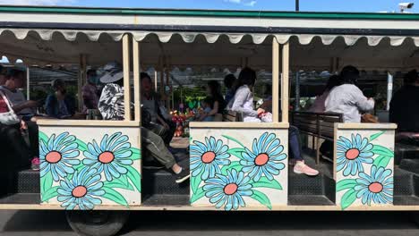 passengers enjoying a tram tour outdoors.