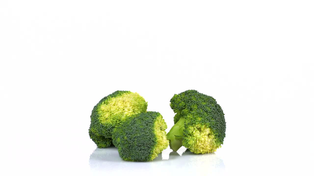 Endless Loop Of a Fresh Broccoli Rotating On a White Background. Side View.