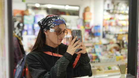 young woman taking photos in a store