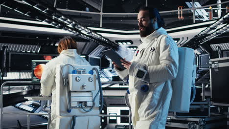 cosmonaut using tablet in spaceship conducting safety checks during expedition