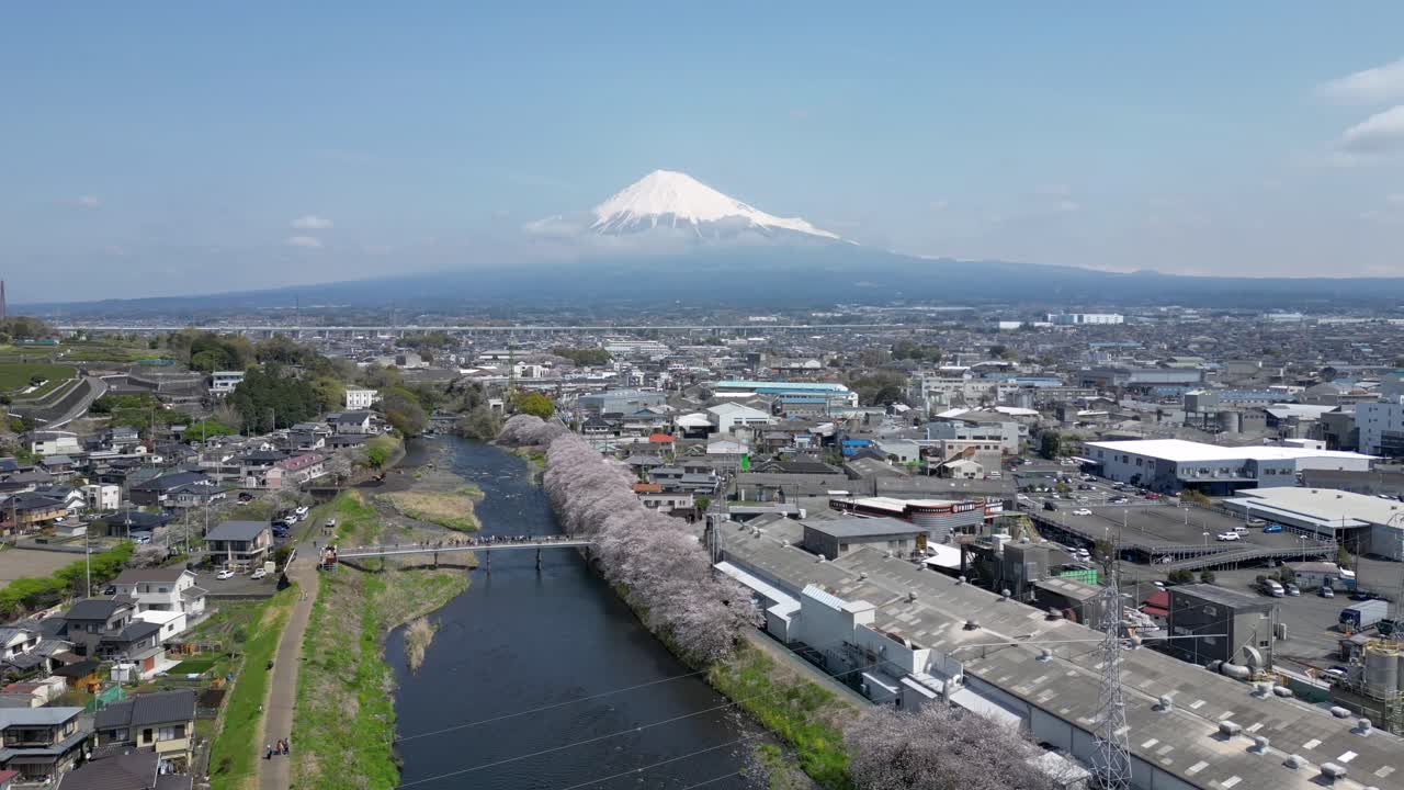 Forward drone shot over landscape in Japan with Mt. Fuji in distance