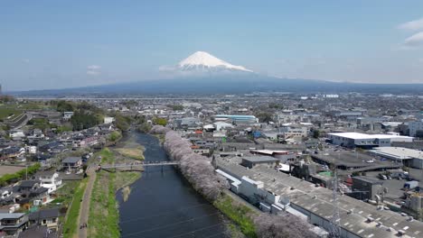 forward drone shot over landscape in japan with mt. fuji in distance