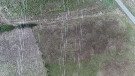 drone shot of power lines over farm fields