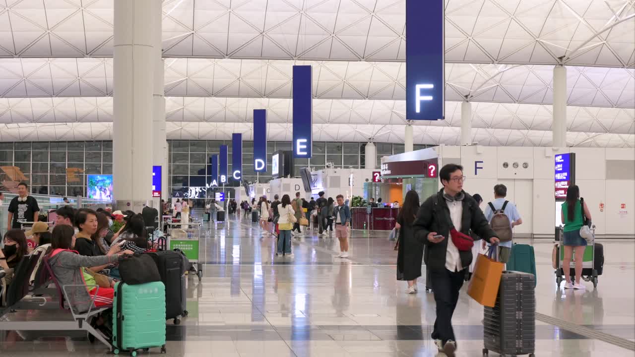 People and luggage in a modern airport terminal