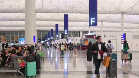 people and luggage in a modern airport terminal