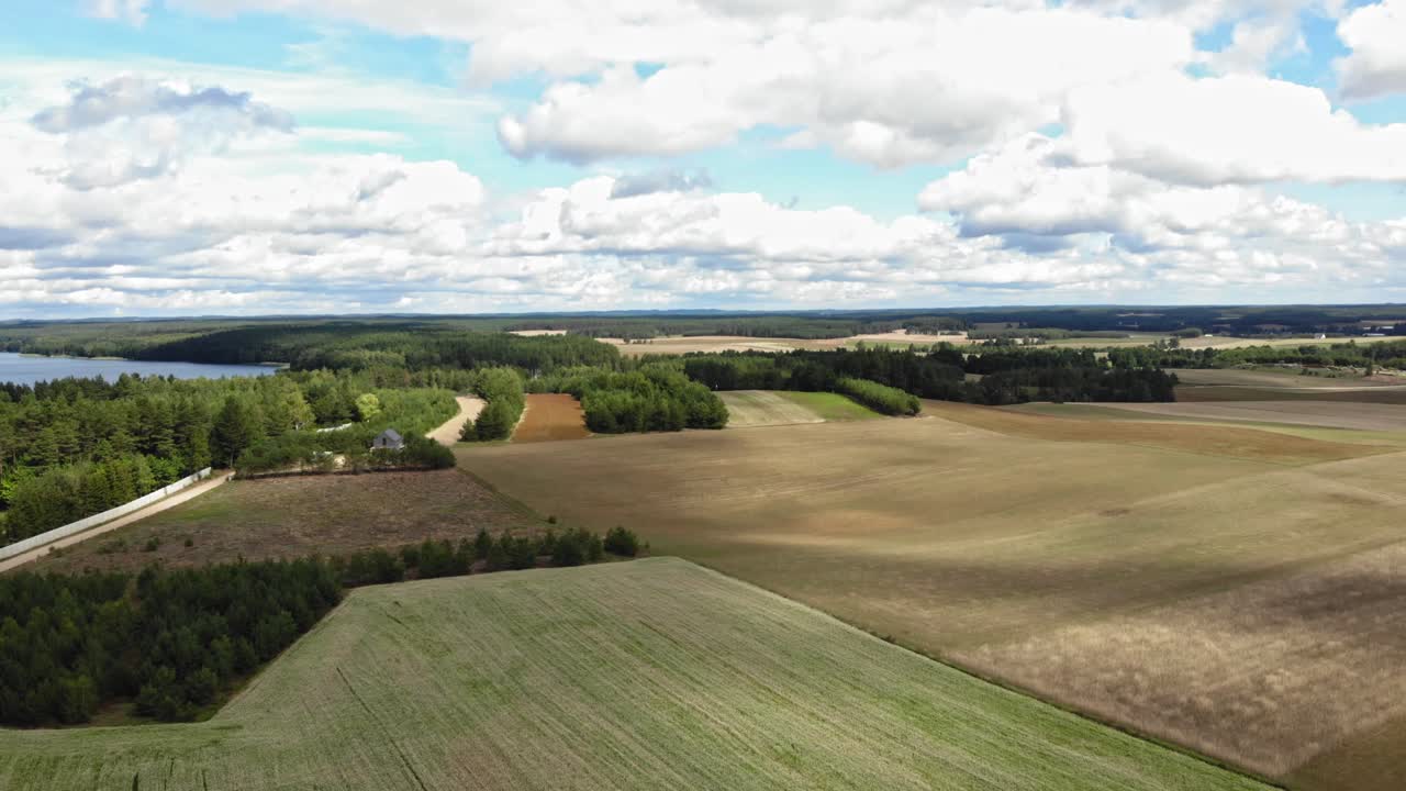 Aerial view of crop fields and a lakea in rural area of Borowy Młyn in Kashubia, Pomeranian Voivodeship, Poland