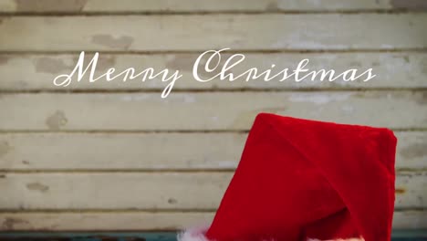 Animation-of-merry-christmas-text-over-santa-hat