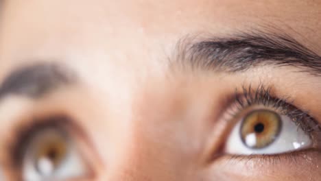 Close-up-of-female-brown-eyes-against-white-background