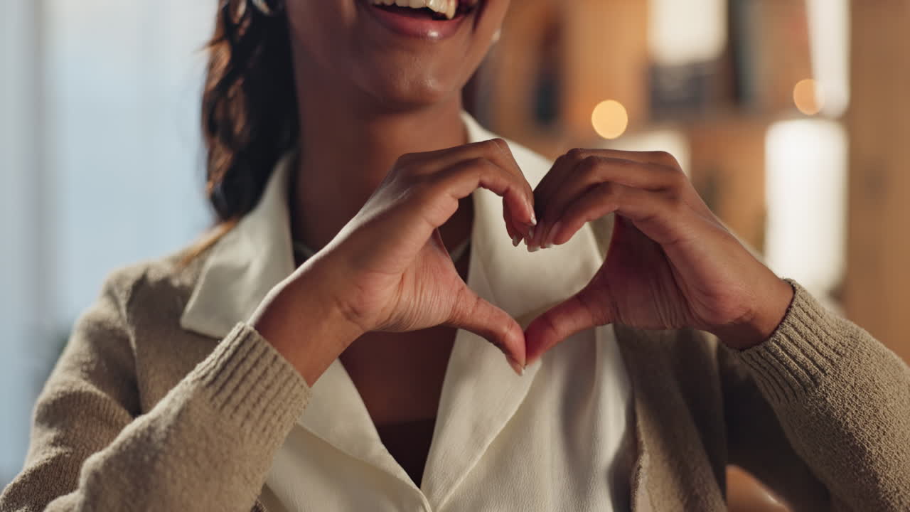 Woman making heart shape with hands expressing love and happiness