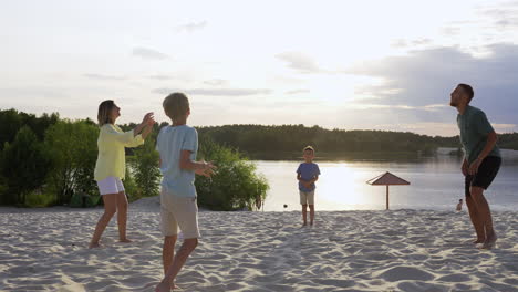 family playing on the beach