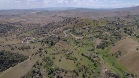 Aerial-orbit-over-the-drying-hills-of-Sicily,-Italy