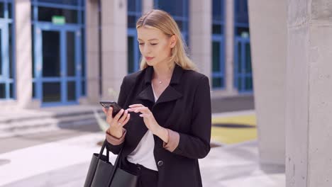 businesswoman using smartphone outdoors