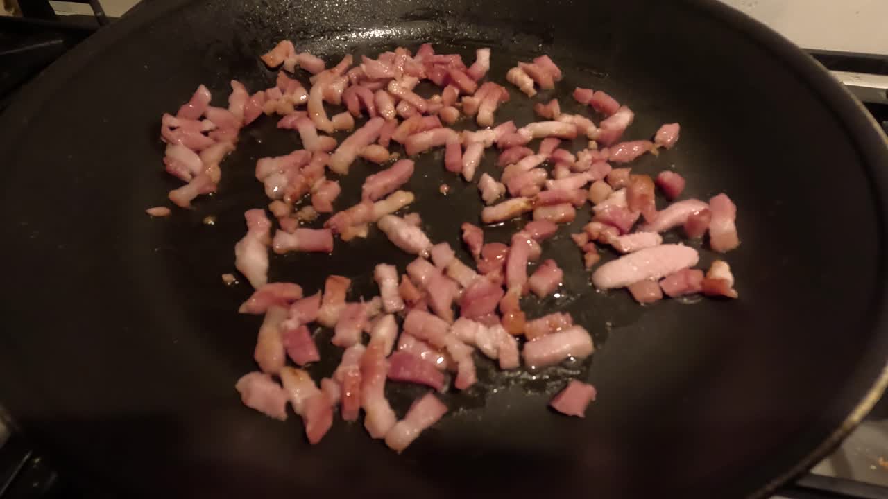 Frying bacon in a pan.