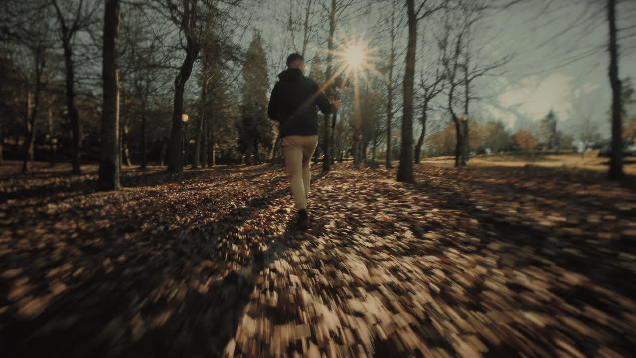 Wide follow shot of a motivated young male videographer