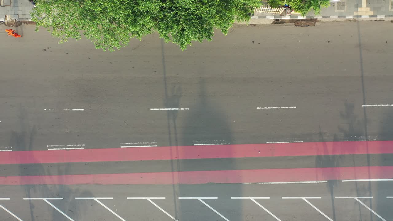Aerial View of City Street with Vehicles and Pedestrians