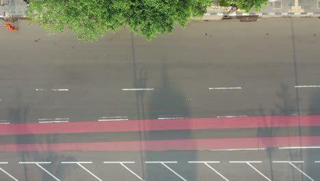 aerial view of city street with vehicles and pedestrians