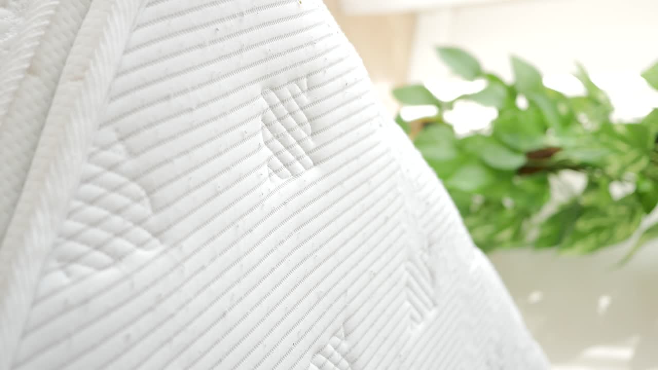 Mattress being pressed by hand