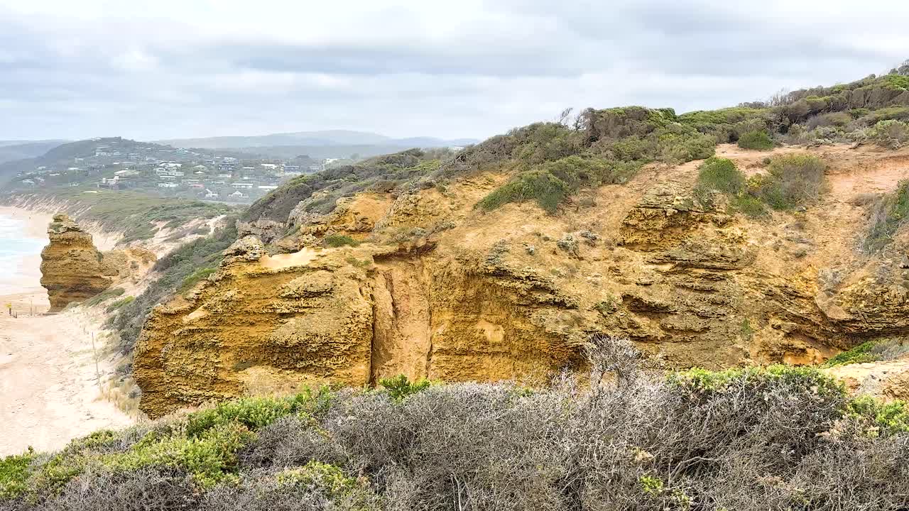 Dramatic coastal cliffs and ocean views under cloudy skies along Australia's Great Ocean Road