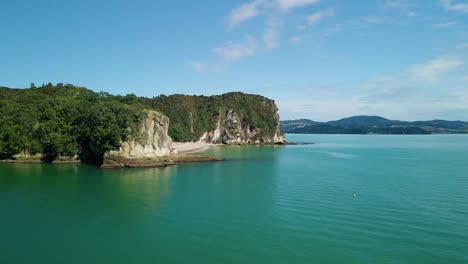 drone flying over tropical island clifftops on summers day