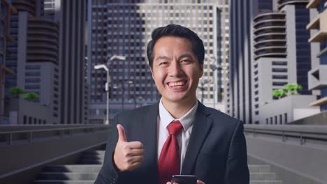 businessman in cityscape giving thumbs up