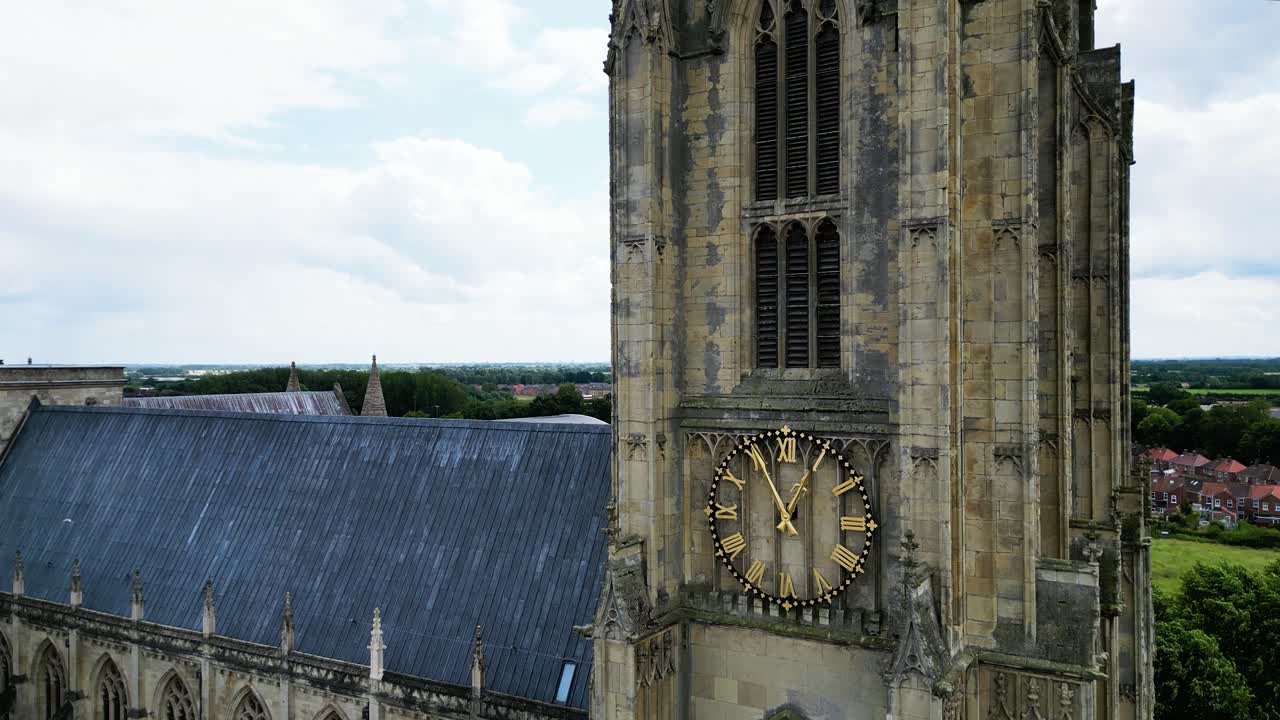 Rising shot of Beverley Minster Yorkshire showing magnificent architecture,clock and tower to its pinnacle