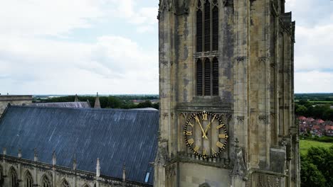 rising shot of beverley minster yorkshire showing magnificent architecture,clock and tower to its pinnacle