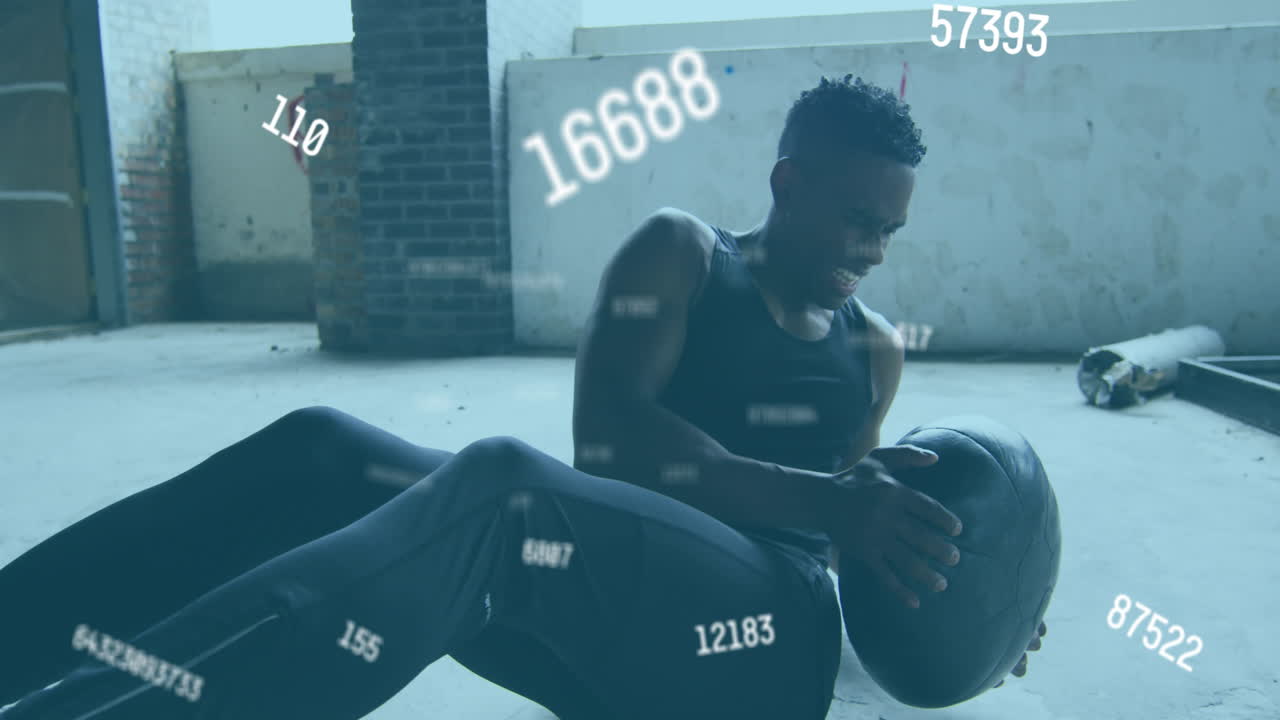 Multiple changing numbers against african american man working out with medicine ball in the gym