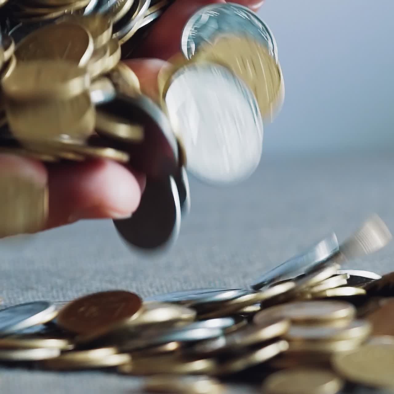 Large number of coins. Hand that holds the money.