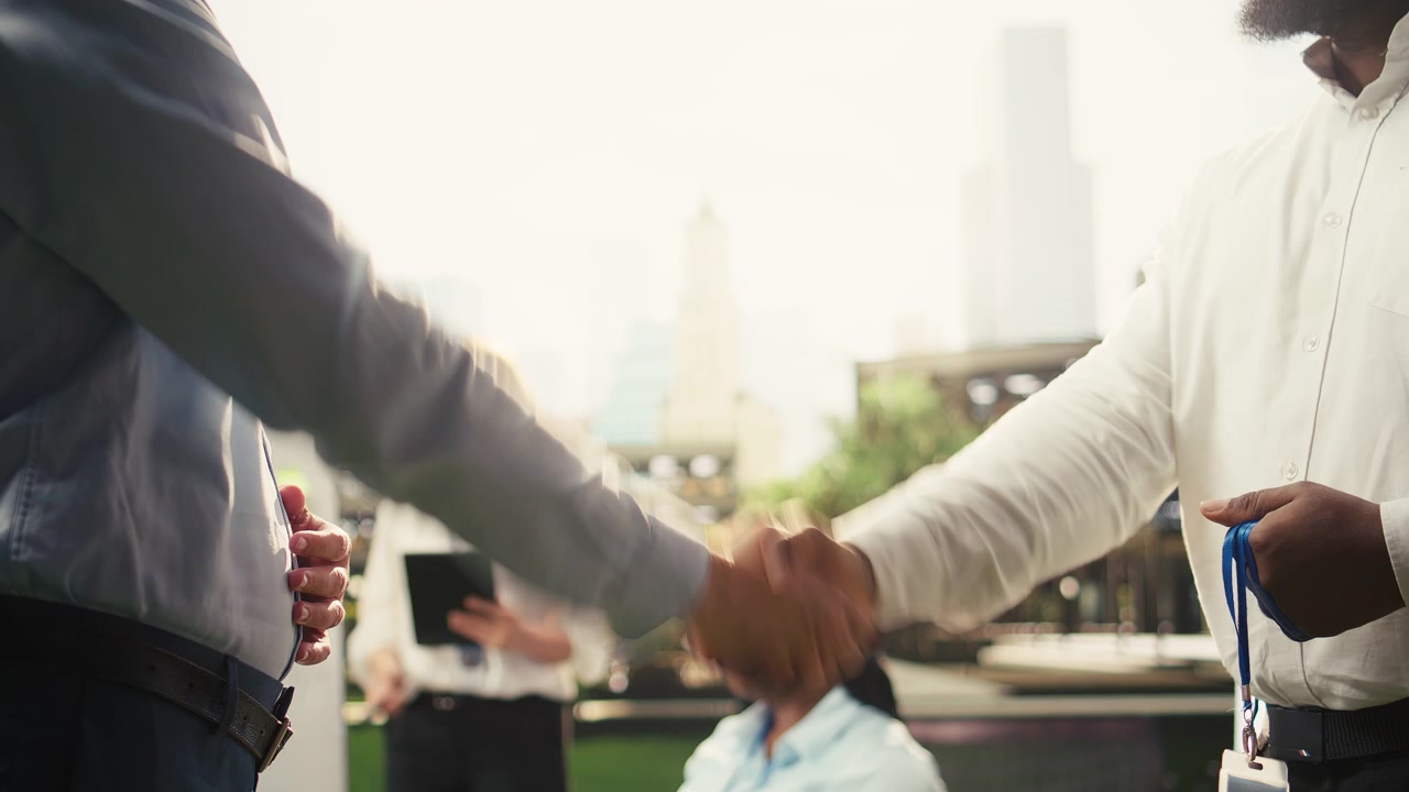 Business Professionals Shaking Hands During Outdoor Meeting
