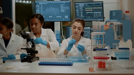 three female scientists working in a modern laboratory