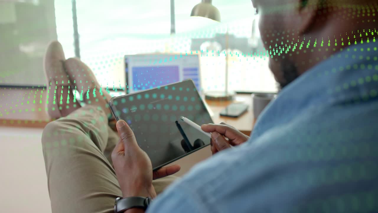 Designer reclining tapping tablet with stylus, causing grid overlay while reviewing design