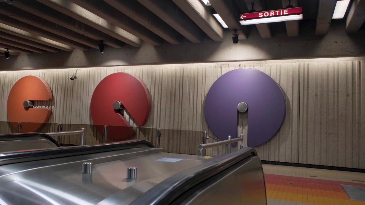 Una scala mobile che sale attraverso l'architettura moderna della metropolitana di Montreal.