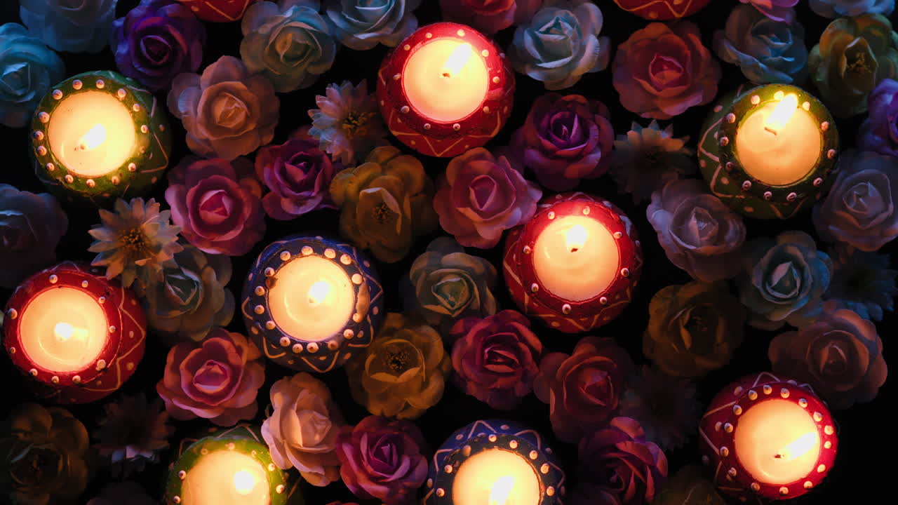 Colorful Diwali candles rotate among flowers for the Indian cultural festival