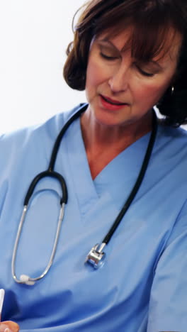 nurse discussing a medical report with woman