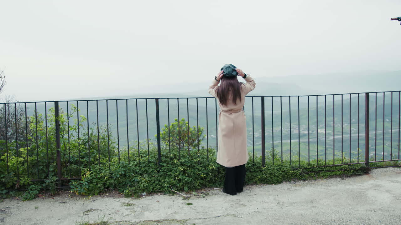 Woman Watching The Panorama From An High Spot In The Town And Waving To People