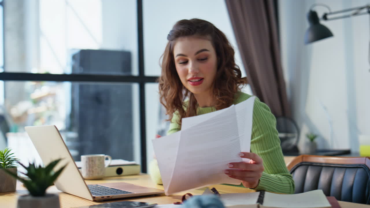 Friendly businesswoman videocalling office closeup. Woman looking documents