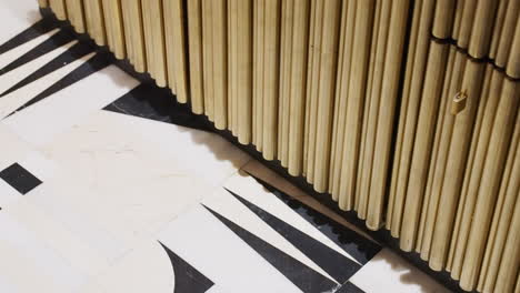 Slatted-Wood-Wall-With-Black-And-White-Tiled-Floor