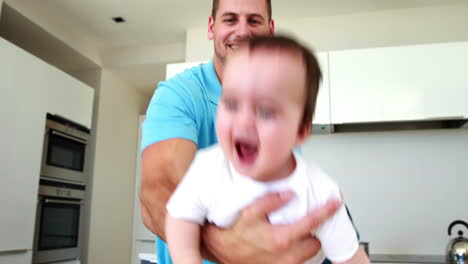 Father-playing-airplane-with-his-baby-boy