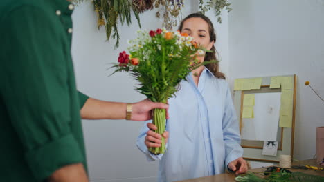 floristry woman give beautiful bouquet flower composition in plant floral shop.