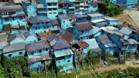 arema blue village, or blue village, an old slum transformed in a touristic place with its blue houses in the bank of the river - malang, east java, indonesia