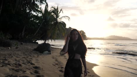 attractive young woman  walking on the beach while smiling on the camera during sunset in canada - close up shot