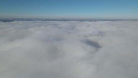 Drone-view-through-cloudy-sky,-aerial-landscape-view