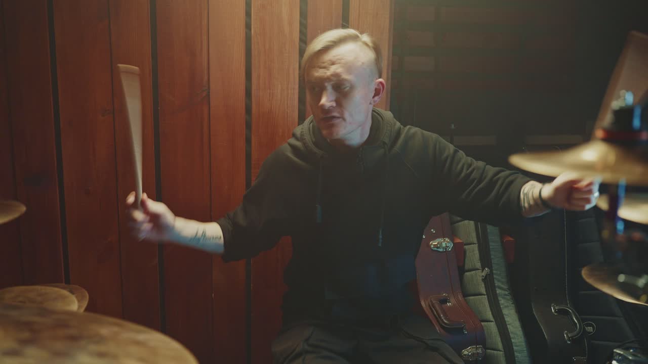 Drummer playing drums in a recording studio