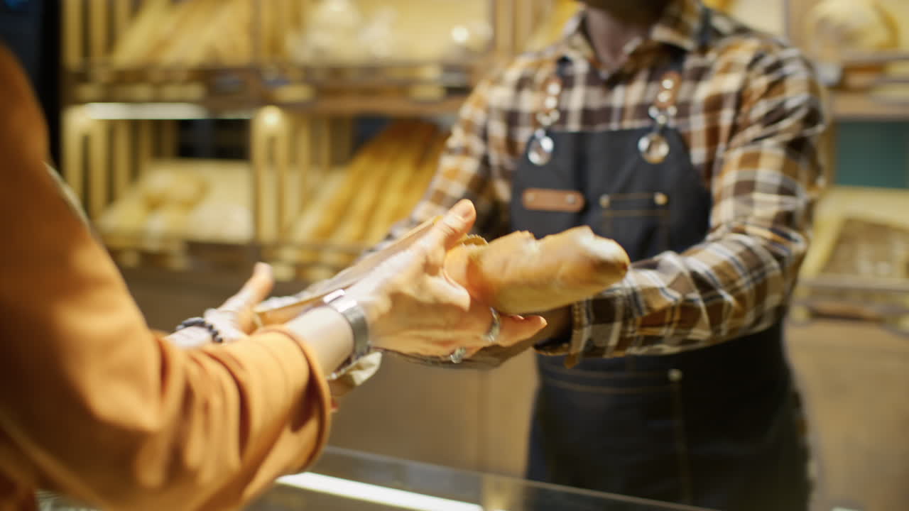 Customer Purchasing Baguette at a Bakery