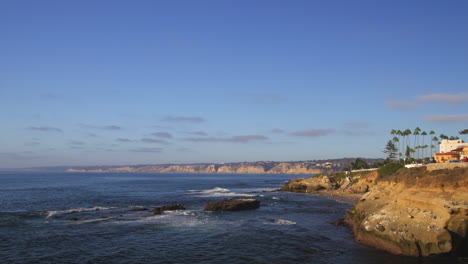 ocean waves gently rolling onto rocky shore at daytime